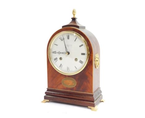 A 20thC mahogany and inlaid mantel clock, the circular enamel dial bearing Roman numerals and the name Comitti, London, eight