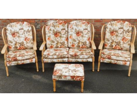 A light beech four piece cottage suite, with floral upholstered cushions, comprising a two seater sofa, 110cm wide, a pair of