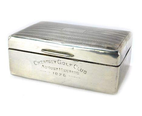 A George V silver cigarette box, of rectangular form with engine turned decoration and vacant cartouche, inscribed Chertsey G