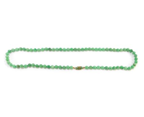 A jade bead necklace, on a jade set yellow metal clasp, stamped 9ct, 104.5g.