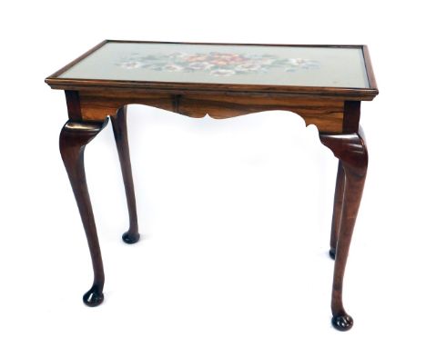 An early 20thC mahogany side table, the top with a wool work tapestry floral inset, raised on cabriole legs, 82cm high, 91cm 