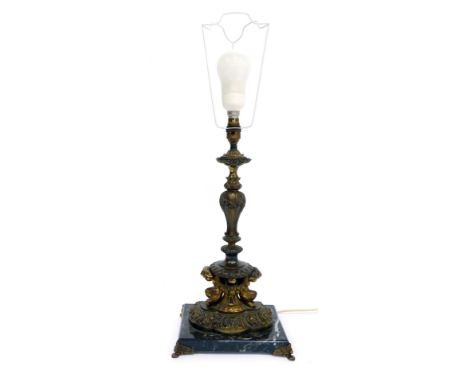 A cast metal table lamp, decorated with cast floral swags, mythical figures, etc, on a marble base, 51cm high.WARNING! This l