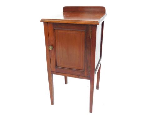 An Edwardian mahogany and inlaid pot cupboard, with a single door, opening to reveal a shelf, raised on tapering square legs,