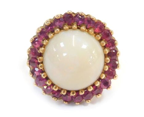 A 9ct gold cluster ring, with central imitation opal, surrounded by garnets, each in claw setting, on a plain band, ring size