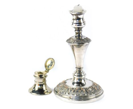 A silver plated inkwell, and a Neoclassical design plated candlestick, the inkwell 5.5cm high, the candlestick 23cm high. (2)