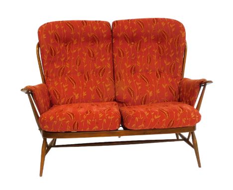 An Ercol elm two seater Windsor sofa, with red foliate fabric, button back cushions, seat cushions and arm rests, 135cm wide.