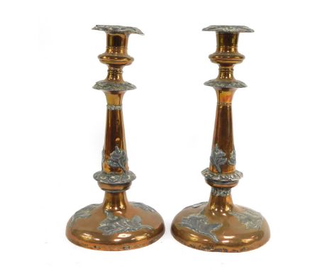 A pair of early 20thC copper and pewter candlesticks, each copper candlestick decorated with pewter flowers, unsigned, 28cm h