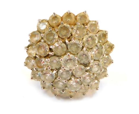 A 9ct gold CZ cluster ring, the chunky design with halo of CZ stones, in a raised basket, size R, 8.3g all in. 