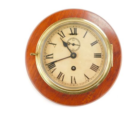 A brass cased ship's clock, the enamel circular dial bearing Roman numerals, subsidiary seconds dial, thirty hour movement, o