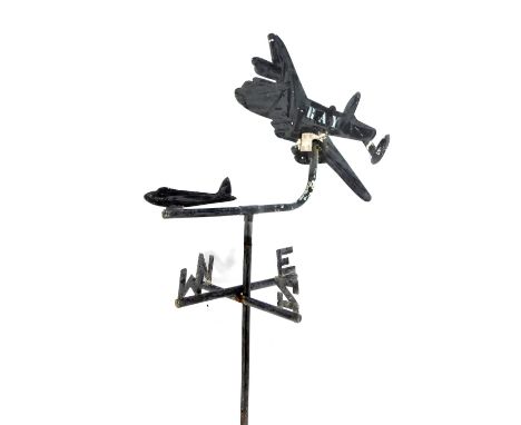 A 20thC painted metal weather vane, modelled as a Lancaster Bomber, initialled RAW, approx 90cm high. (AF)