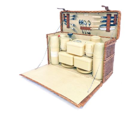 A mid century Coracle picnic hamper and contents, 56cm wide. 