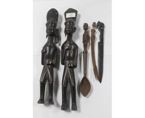 TWO AFRICAN CARVED HARDWOOD FIGURES, a carved wooden spoon with African soldier finial and two other minor carved items  (5)