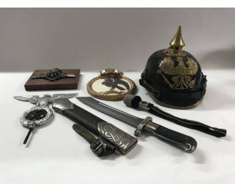 A group of German and other style items including a recreation dagger with scabbard, a Pickelhaube, spare SS toggle, a pole a