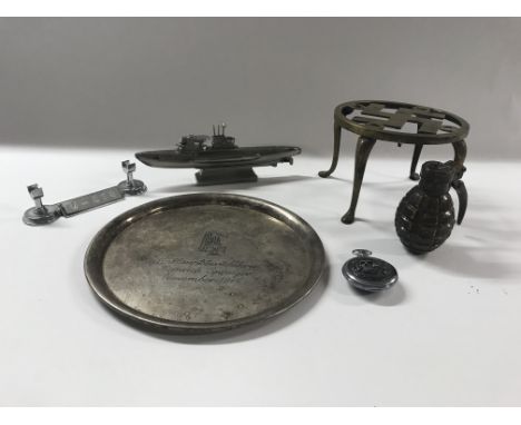 A group of militaria oddments comprising of a Lighter in the form of a U-Boat, a lighter in the form of a grenade, a Waffen S