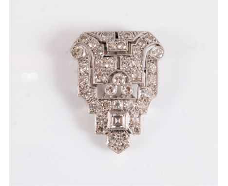 An Art Deco diamond dress clip, of stepped form and the pointed top set with a single square step cut diamond, round brillian