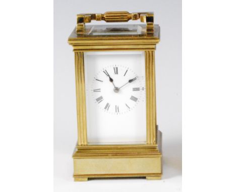A late 19th century French lacquered brass carriage clock, having swing carry handle and visible platform escapement, over a 