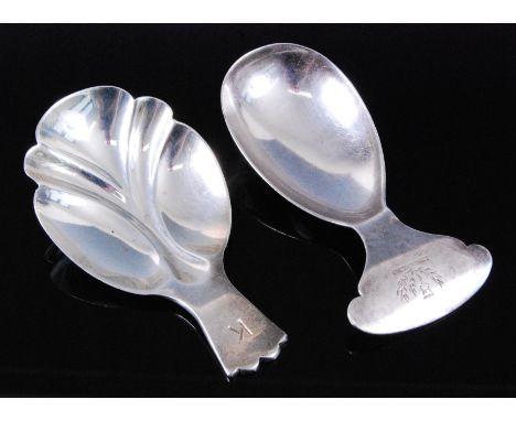 A George V silver caddy spoon, having a plain tear-drop shaped bowl with thistle crest to the terminal, maker William Hutton 