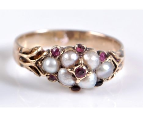 A mid-late 19th century split pearl and ruby ring, the central ruby surrounded by four split pearls, with a further split pea