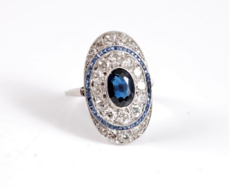 An early 20th century oval sapphire and diamond ring, the oval plaque set with a central collet mounted oval sapphire, approx