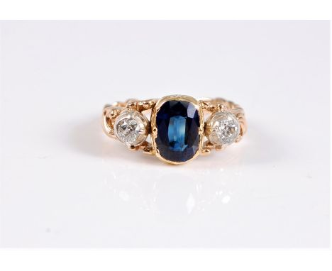 A late 19th century sapphire and diamond ring, the central oval sapphire, approx. 8.8 x 6.8 x 3.2mm, in a rubover mount, set 