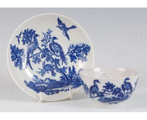 A Worcester porcelain blue and white tea bowl and saucer, printed in the Birds in Branches pattern, both with crescent C mark