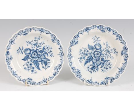 A pair of Worcester porcelain tea plates, each blue and white printed in the Pinecone pattern, circa 1770-85, hatched crescen