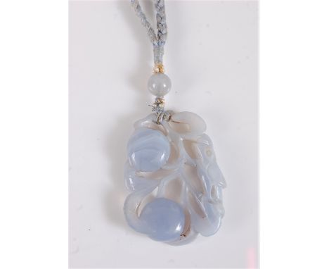 A Chinese carved chalcedony pendant, the rectangular carved pendant of two lotus fruits and a bird, 48 x 36mm, with chalcedon