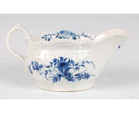 A Worcester porcelain press-moulded sauceboat, underglaze blue painted in the Two Porter landscape pattern, open crescent mar