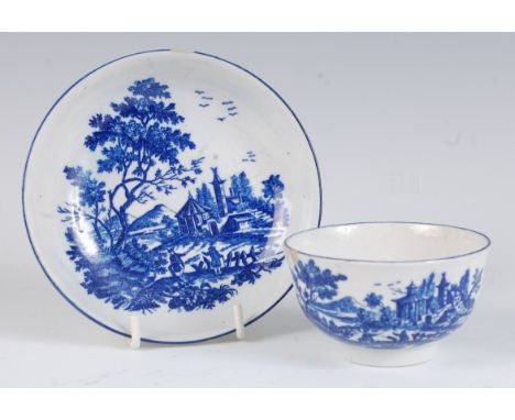 A Worcester porcelain blue and white tea bowl and saucer, printed in the European Landscape Group pattern, crescent mark vers