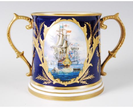 A Lynton Porcelain Company loving cup, decorated with opposing reserves of British naval frigates, signed Stefan Nowacki, all