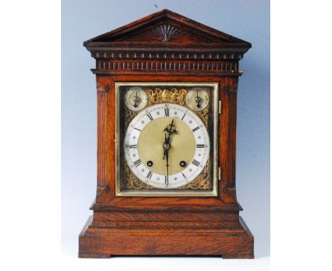 A circa 1900 German oak cased bracket clock, having square brass dial with silvered chapter ring, subsidiary chime/silent and