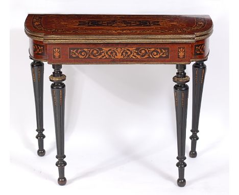 A 19th century amboyna and marquetry inlaid breakfront card table, the fold-over top having embossed brass edge, with swivel 