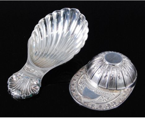 An E.R. II. novelty silver caddy spoon in the form of a jockeys cap, having a vacant shield shaped cartouche to the peak, mak