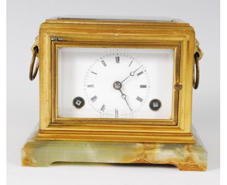 An early 20th century lacquered brass and onyx mantel clock by Moulinie of Geneva, having visible platform escapement over si