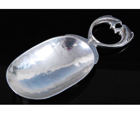 An Arts & Crafts silver caddy spoon, having an oval spot hammered bowl and stylized leaf handle, maker Alfred Edward Jones, B