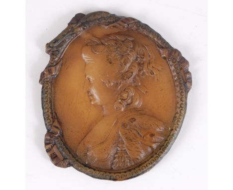 An early 19th century wax relief profile portrait of a lady with ribbons in her hair, possibly Marie Antoinette, as an oval w