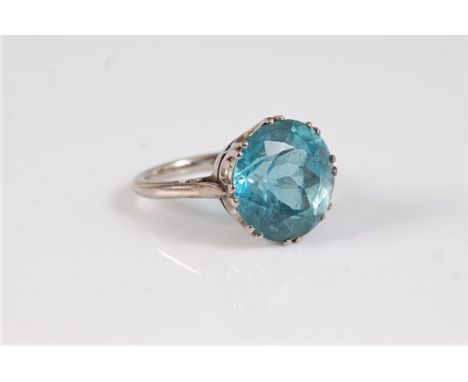 An 18ct aquamarine single stone ring, the round mixed cut aquamarine, approx. 13.5mm diameter, claw mounted, all in white gol