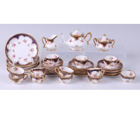 A Crown Staffordshire porcelain dolls part tea set, decorated in bright enamels with floral sprays on a white ground within c