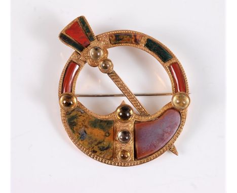 A twentieth century Scottish agate brooch, the round brooch with diagonal dagger inset with mixed agate and jasper specimens,