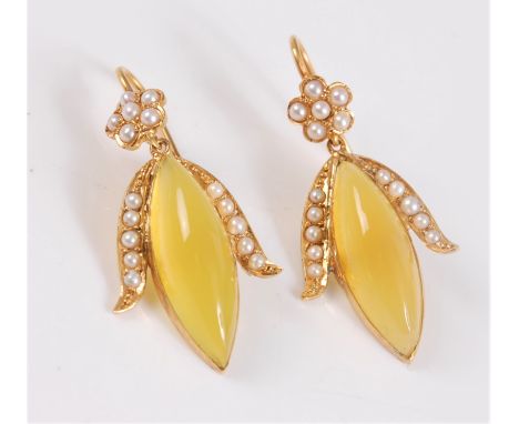 A pair of seed pearl and yellow hardstone (probably fire opal) earrings, the marquise shaped yellow hardstone cabochons, set 