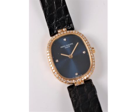 A lady's 18ct Patek Philippe Ellipse diamond mechanical wristwatch, the blue dial with diamond quarter dot markers, with diam