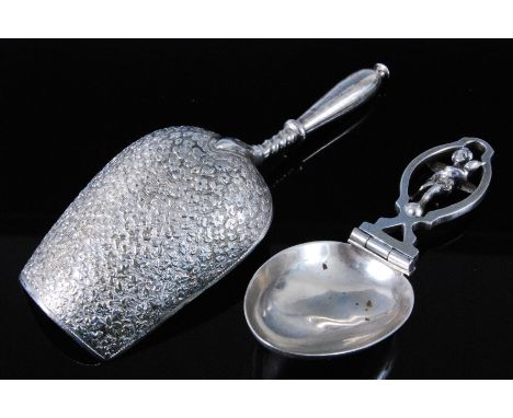A late 19th century Russian silver caddy spoon, the deep shovel shaped bowl monogrammed M with foliate engraving to the under