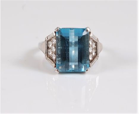 An aquamarine and diamond ring, the step cut aquamarine, approx. 12.1 x 9.2 x 6.8mm, in a four claw mount, set to either side