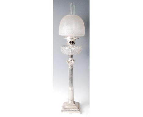 An Edwardian silver Corinthian column oil lamp, having diamond cut and engraved frosted glass shade, hobnail cut font, the st