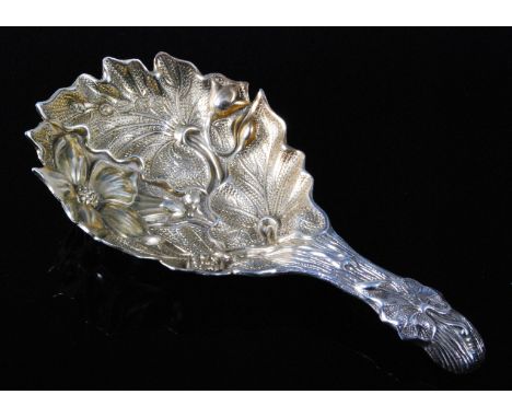 A Victorian silver caddy spoon, the gilt washed bowl repousse decorated with flowers and leaves, maker Chawner & Co (George W