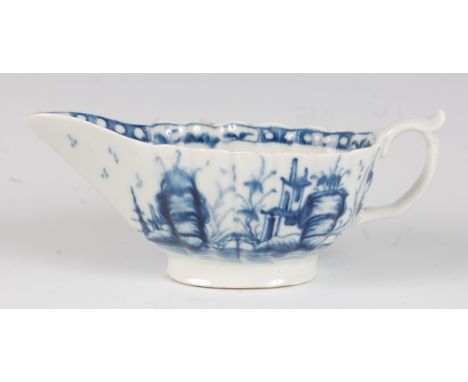 A rare Worcester porcelain sauceboat, underglaze blue painted in the Mission Church pattern, having press-moulded fluted body