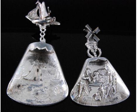 A 19th century German silver caddy spoon, the triangular bowl embossed with boats upon a river with pierced stem and further 