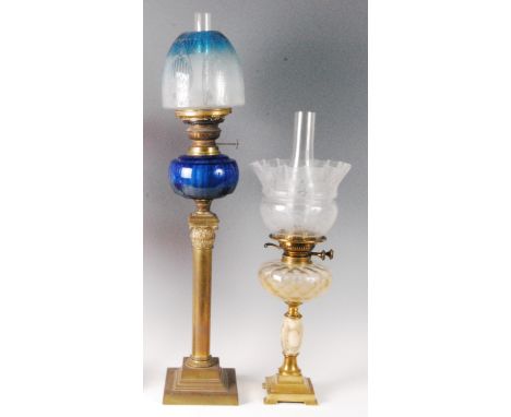 A late Victorian brass pedestal oil lamp, having a blue glass and acid etched shade, with blue glass font, h.72cm; and one ot