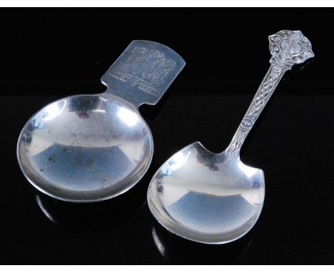 An E.R. II Prince of Wales Investiture silver caddy spoon, having a circular shallow bowl, the handle engraved with Fluer de 