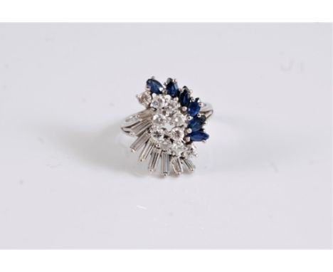 An 18ct sapphire and diamond cocktail ring, the two interlocking arc's of round brilliant cut diamonds set to either side wit